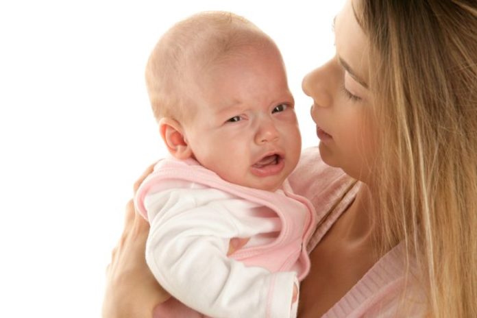 Mum comforting crying baby