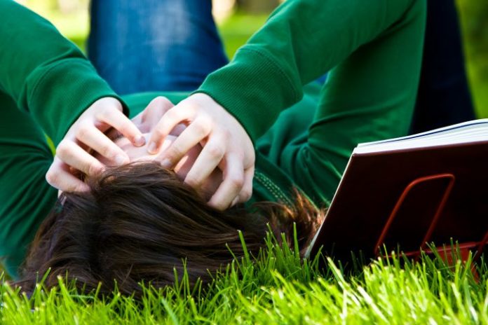 Tired teenager on grass