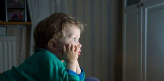 Little boy watching TV.