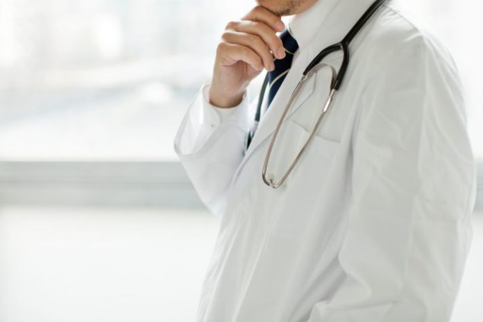 A doctor in white coat.
