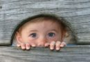 Child peeking through hole