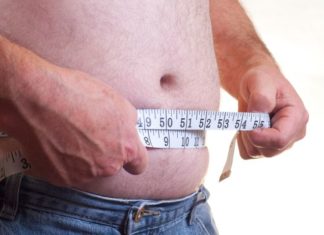Man measuring stomach.