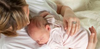 Mum watching baby sleep