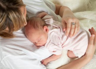 Mum watching baby sleep