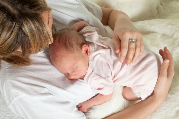 Mum watching baby sleep