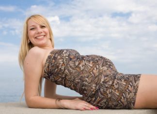 Pregnant woman smiling and looking at camera