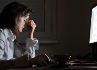 Woman working late, tired and stressed