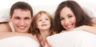 Parents and child in bed