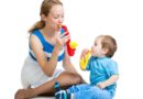 Mother and kid play with musical toys