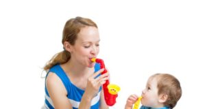 Mother and kid play with musical toys