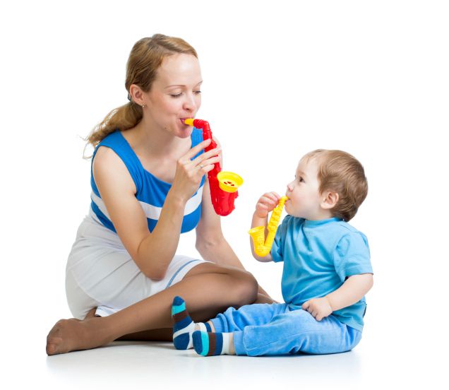 Mother and kid play with musical toys