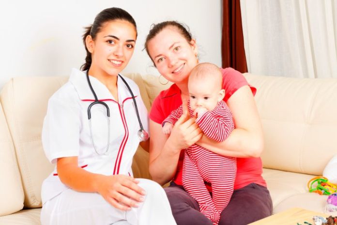 Midwife helping mum at home