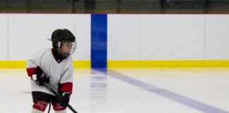 Little boy playing ice hockey