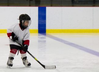 Little boy playing ice hockey