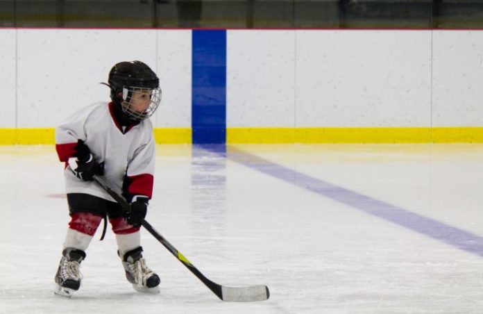 Little boy playing ice hockey