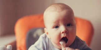 Portrait of little girl holding spoon