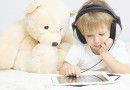 little boy with headset using touch pad