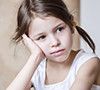 Dissatisfied preschooler girl in the kitchen