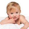 A thoughtful baby boy in the bed on the white background
