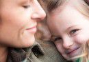 Shy smiling little girl with mother