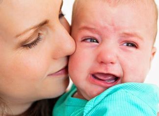 Mother settling crying baby