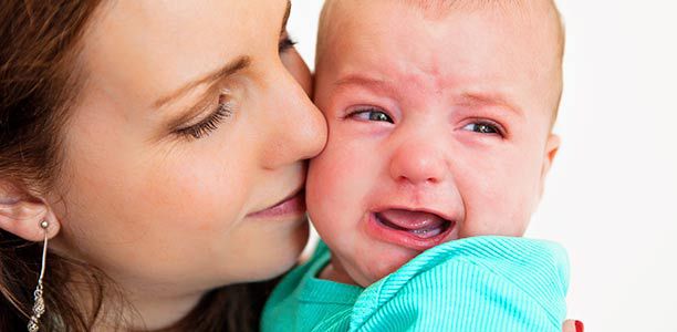 Mother settling crying baby
