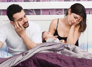 exhausted parents with newborn baby