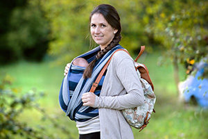 Mother with a baby sling and bag