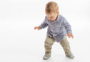 baby-boy-toddler-learning-to-walk-whitebackground-300×200