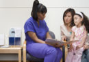 Nurse talking to mother and daughter