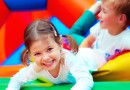 happy kids having fun on playground in kindergarten