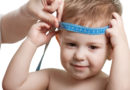 Measuring the head of a child with tape