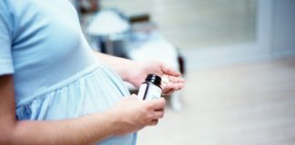 Pregnant woman taking tablets