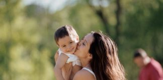 Mother kissing son