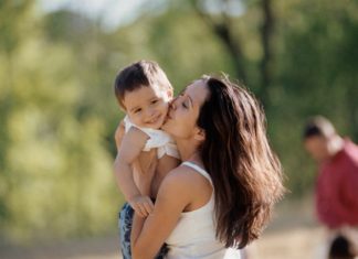 Mother kissing son