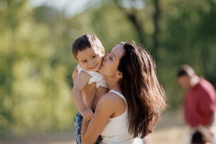 Mother kissing son