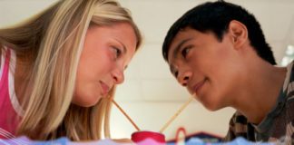 Teen couple sharing a drink