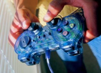 A child's hands holding a video game controller.