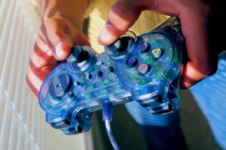 A child's hands holding a video game controller.