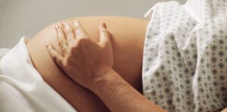 Pregnant woman in hospital gown