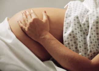 Pregnant woman in hospital gown