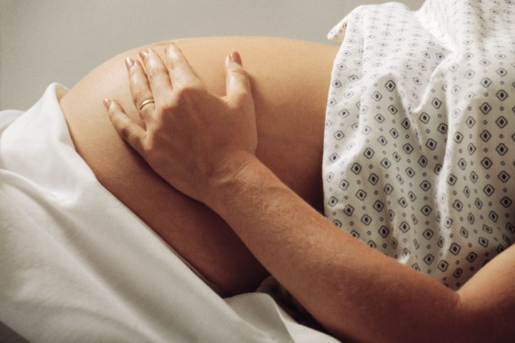 Pregnant woman in hospital gown