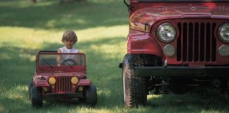 Child in toy jeep