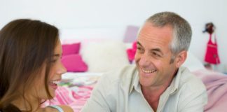 Father and teen daughter chatting and laughing