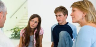 Parents talking to children. A serious looking conversation.