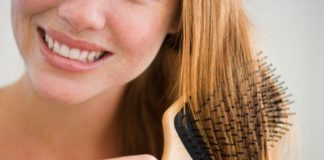 Woman brushing hair with paddle brush