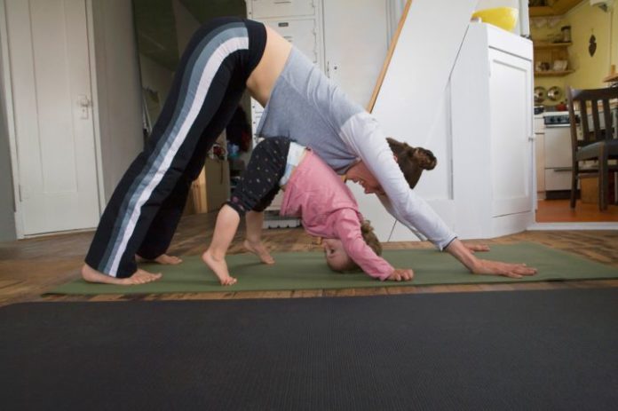 Woman and toddler doing yoga