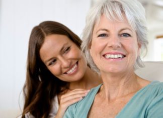 Portrait of smiling mother and daughter.