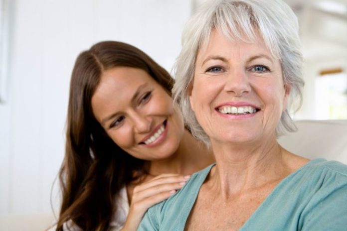 Portrait of smiling mother and daughter.