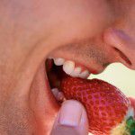 Man eating strawberry